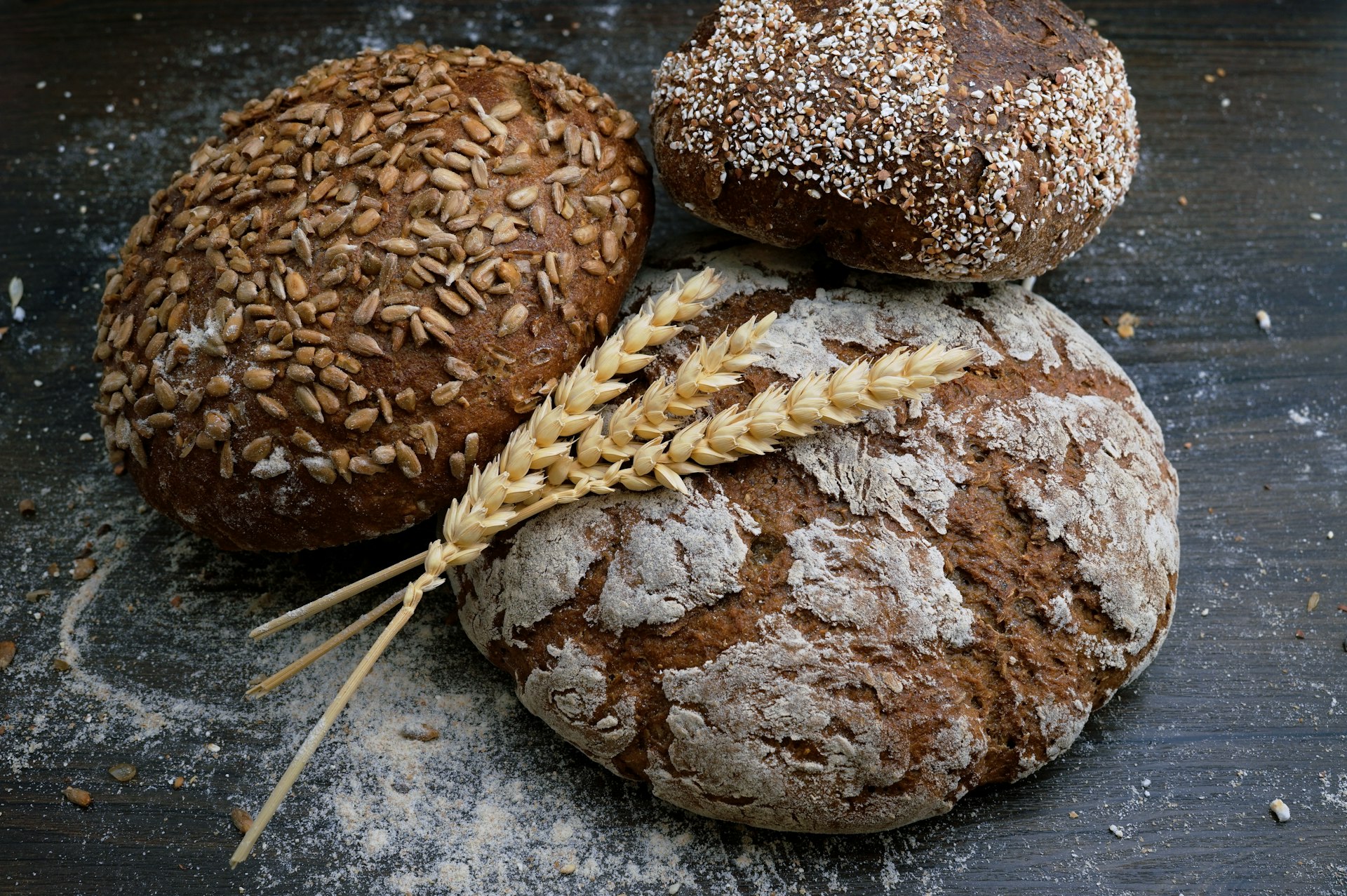 Display of golden brown freshly baked croissants and artisan sourdough bread on a marble countertop